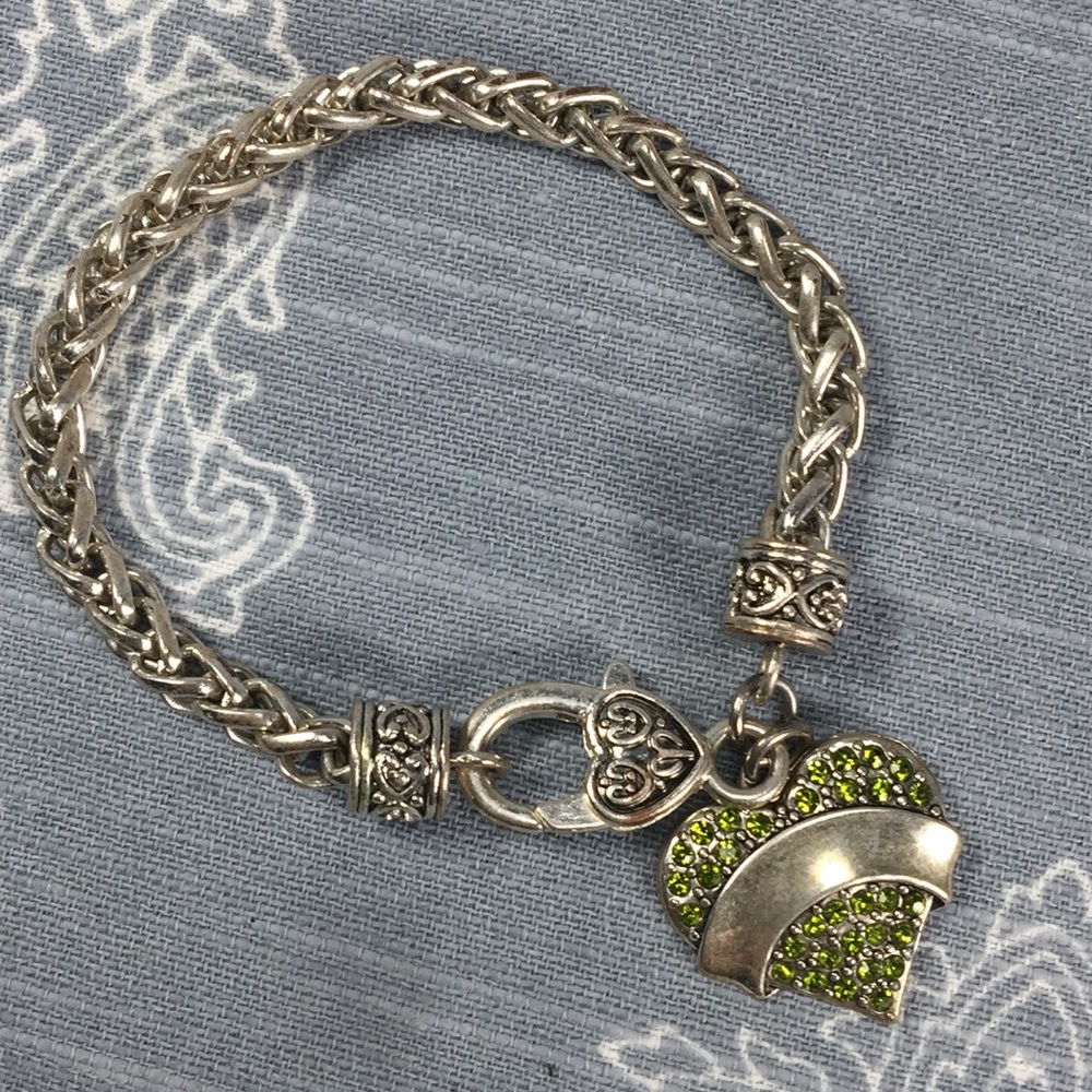 Silver tone bracelet with green heart